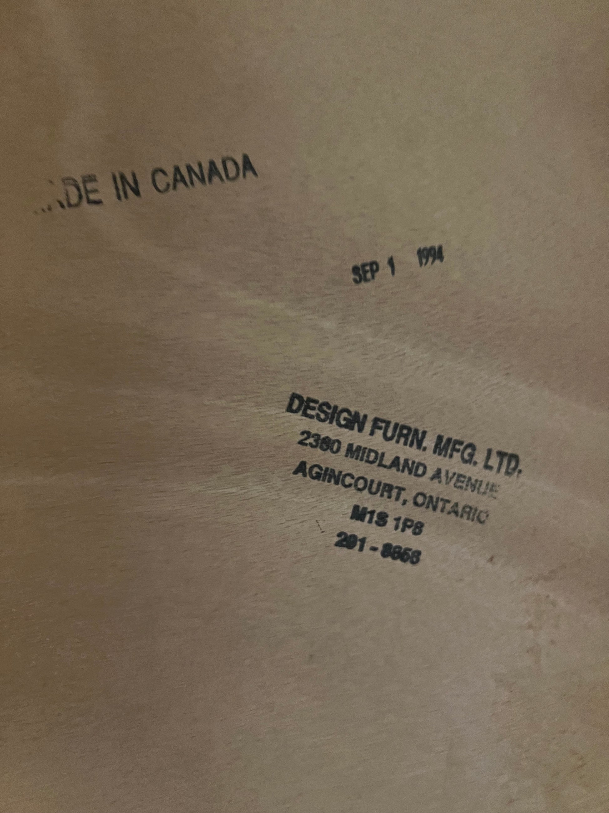 Image showing stamps on Vintage Teak Bed that say "Made in Canada, Sep 1 1994, Design Furn. MFG. LTD. Midland Ave. Ontario"